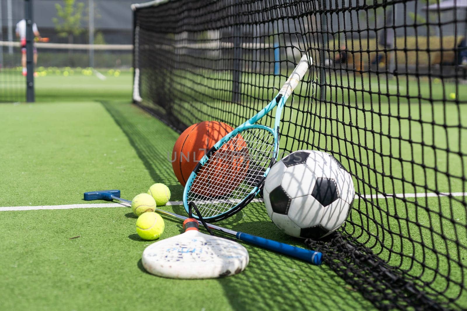 A group of sports equipment on background including tennis, basketball, and soccer on a background with copy space. High quality photo