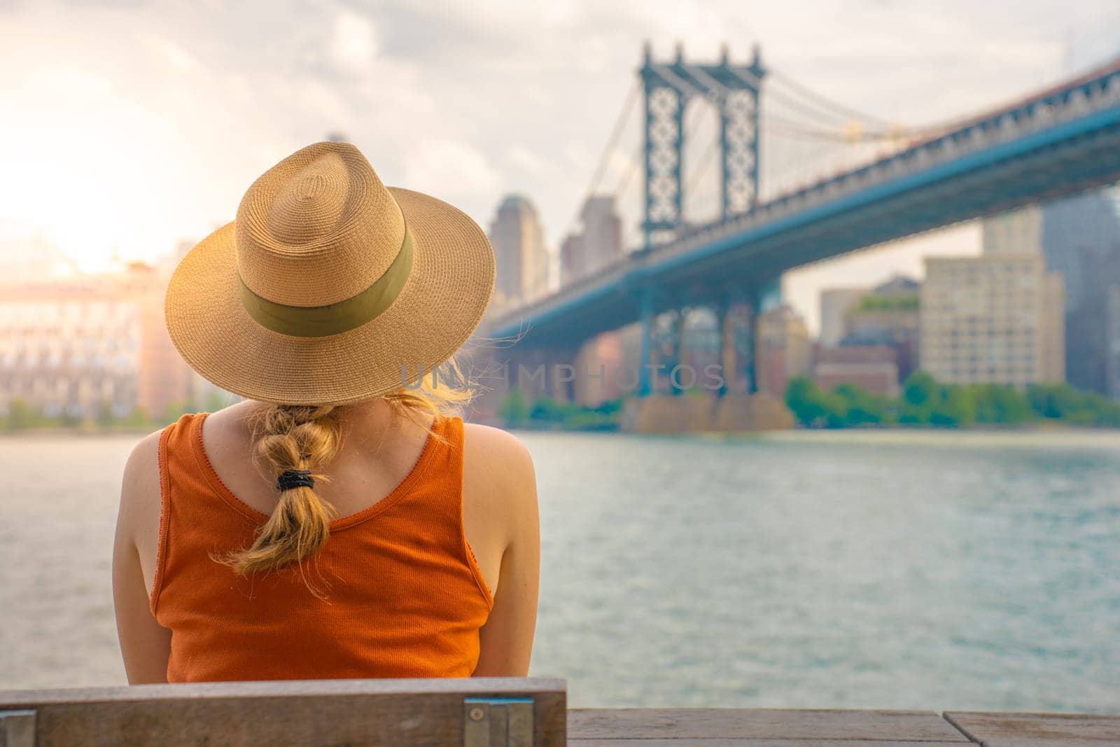 Back view of attractive young woman with hat in New York City. Travel, freedom and adventure concept. High quality photo