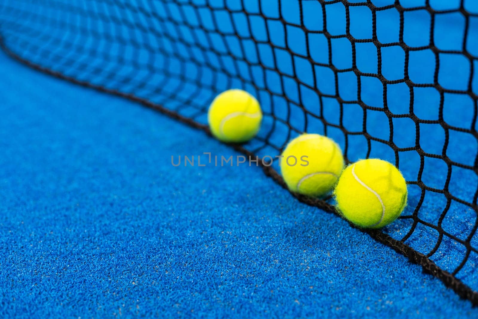 paddle tennis racket and balls on court, night image. High quality photo