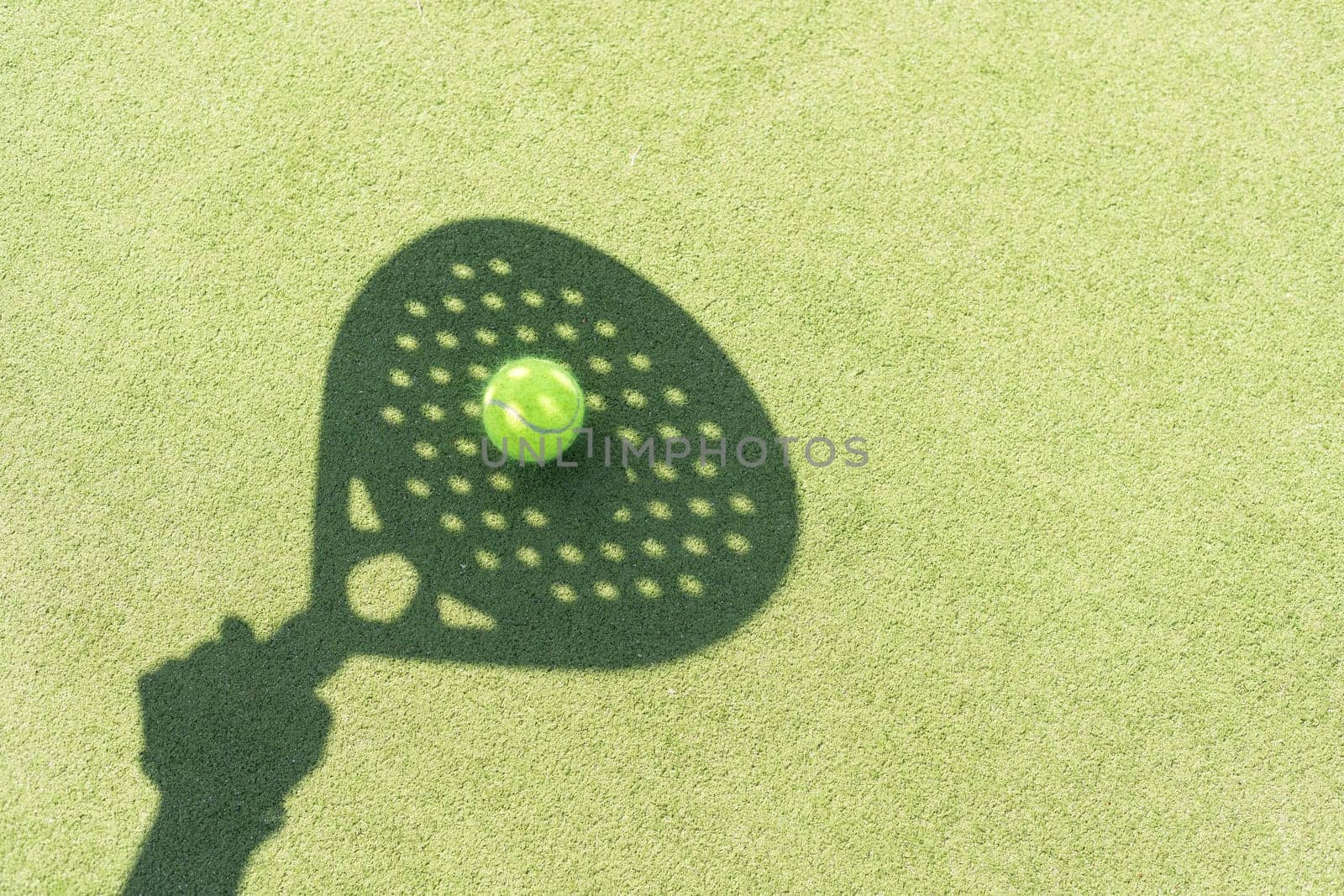 Paddle tennis racket shadow on balls. High quality photo
