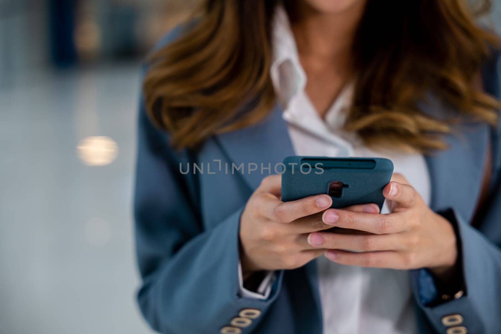 Female hands typing message on smartphone by Sorapop