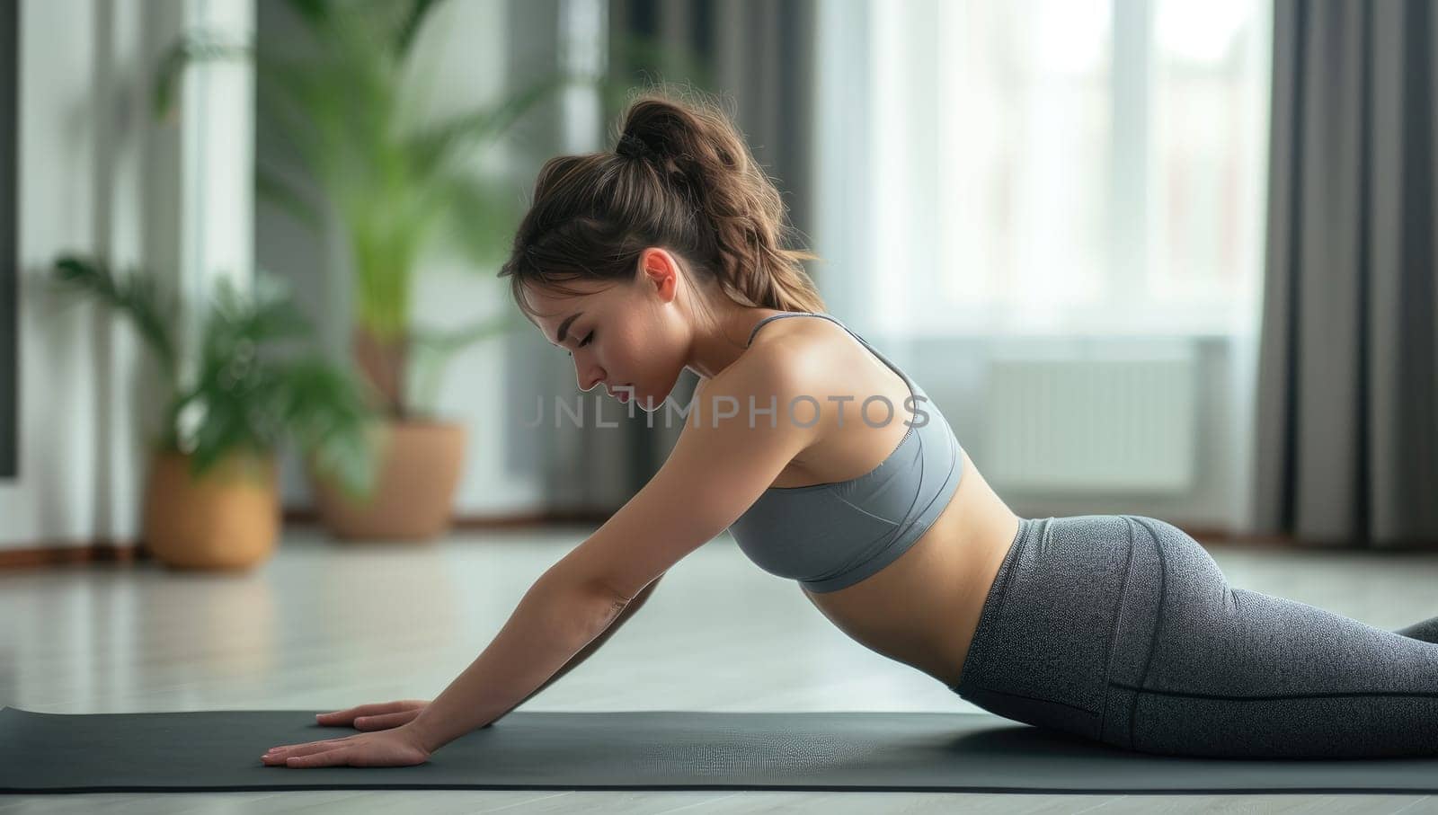 Beautiful young woman doing yoga exercise at home. Healthy lifestyle concept. by ailike