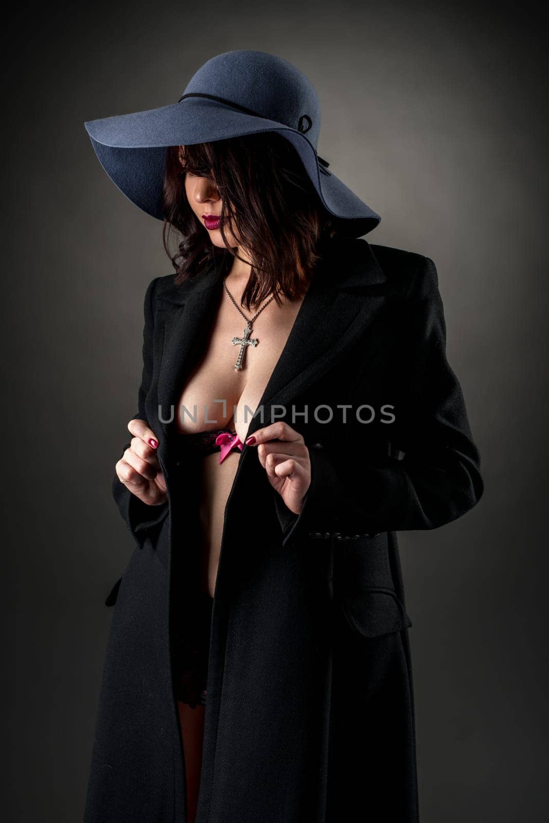 Studio photo of glamorous dressed woman bared her breasts