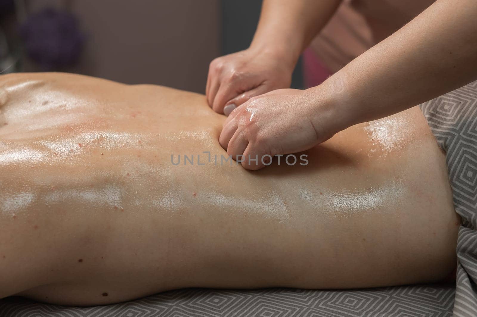 Woman having a therapeutic back massage. by mrwed54