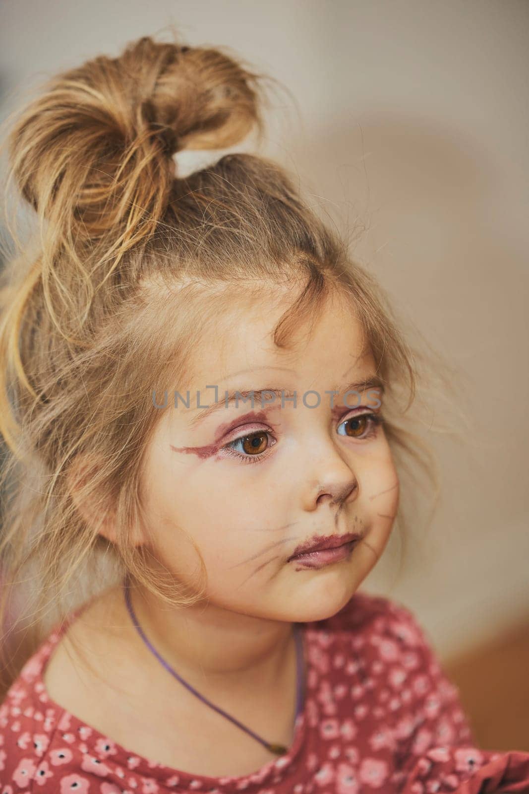 Charming child made makeup with felt-tip pens at home.