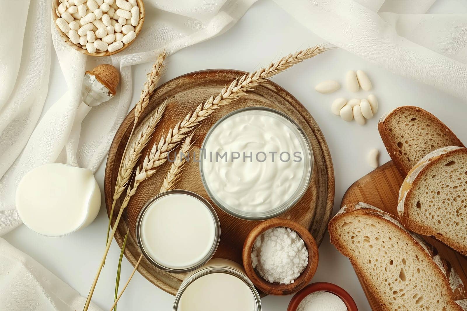 A table displaying an assortment of bread, cheese, and other foods for Shavuot celebration.