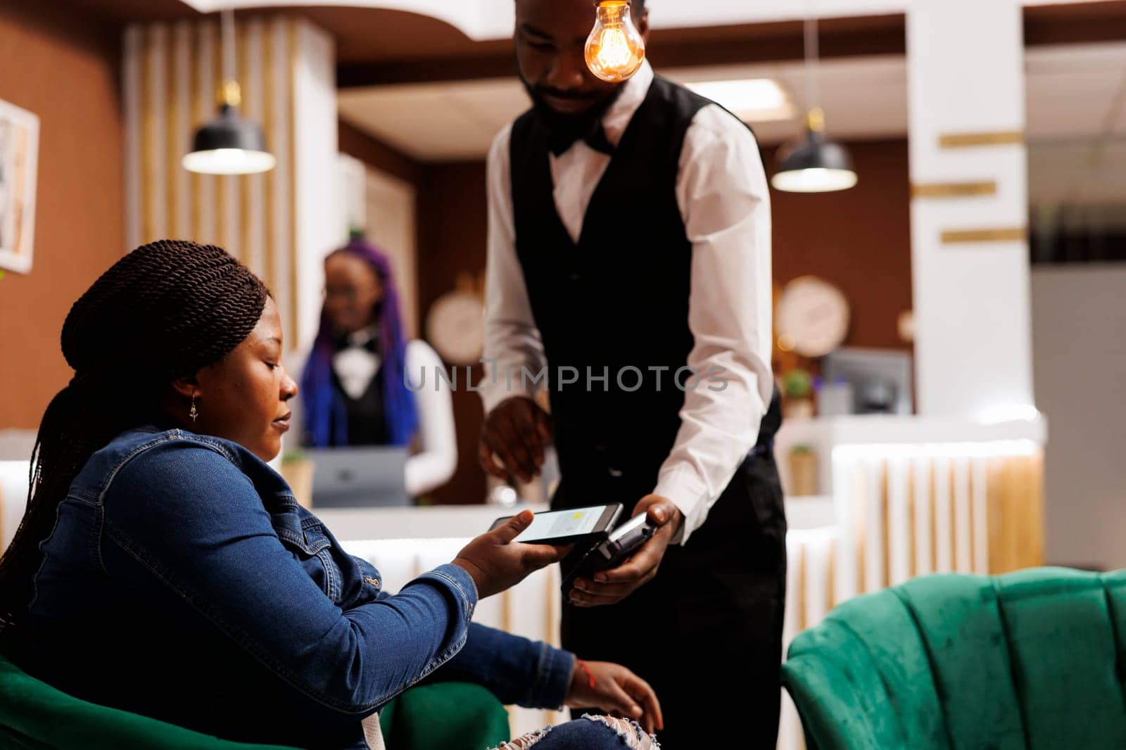Hotel guest making contactless payment by DCStudio