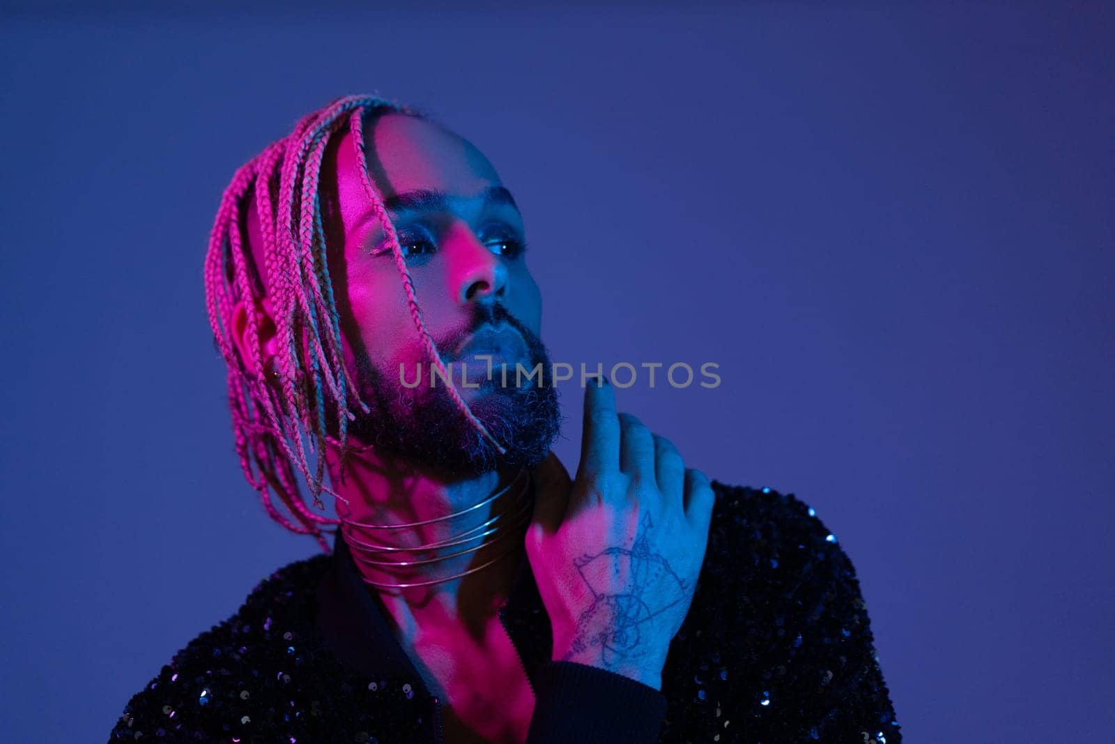 Retro wave or synth wave portrait stylish serious african-american dancer man studio shoot. High Fashion male model dance in colorful bright neon lights posing. Art design concept