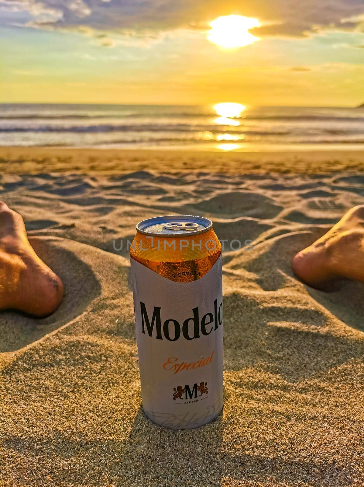 Modelo beer can on the beach at sunset in Mexico. by Arkadij