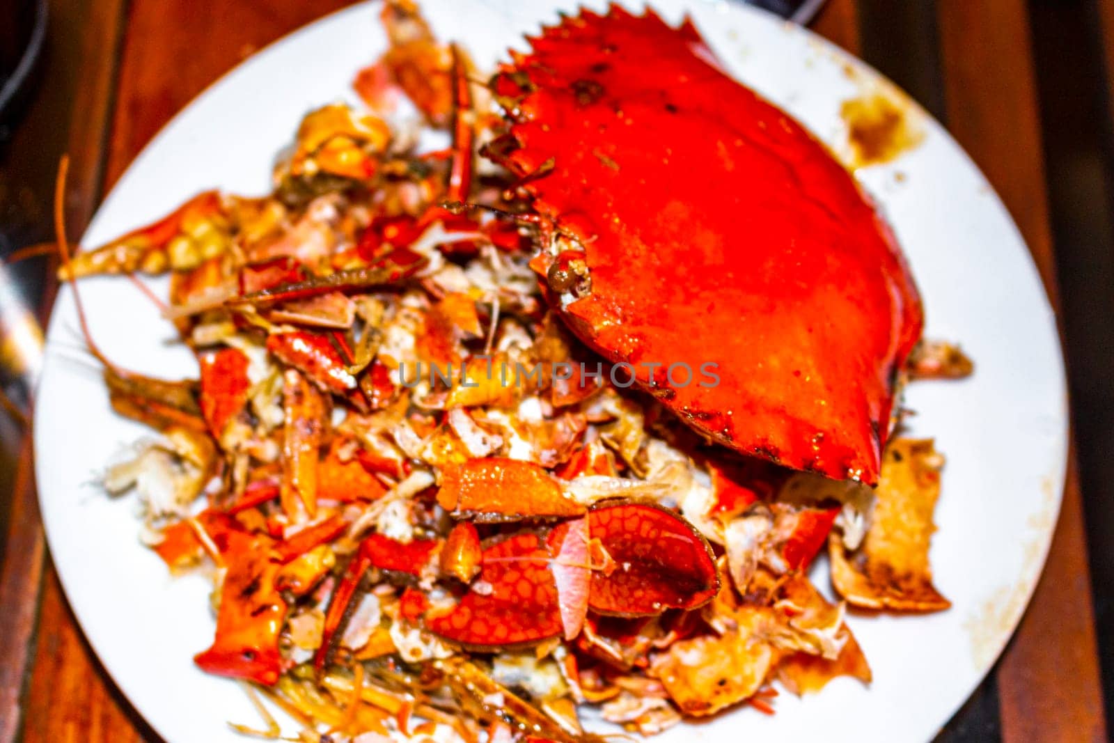 Lobster Shrimps Crabs Squid Seafood on plate in the hand in Bentota Beach Galle District Southern Province Sri Lanka.