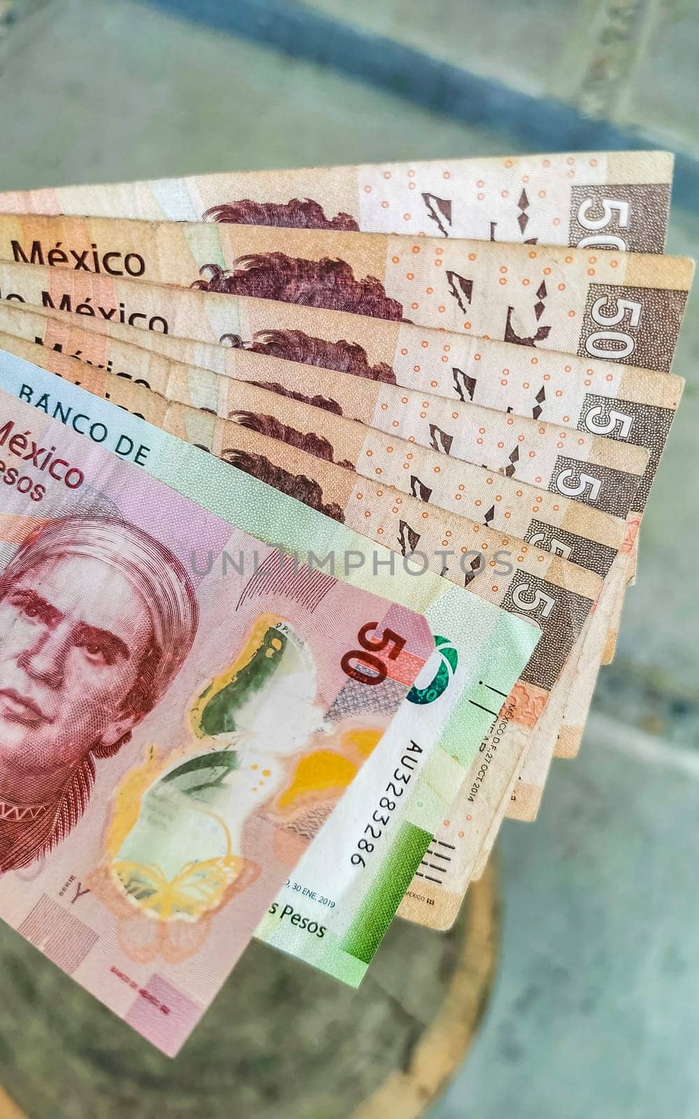 Money Mexican peso bills in hand in Zicatela Puerto Escondido Oaxaca Mexico.