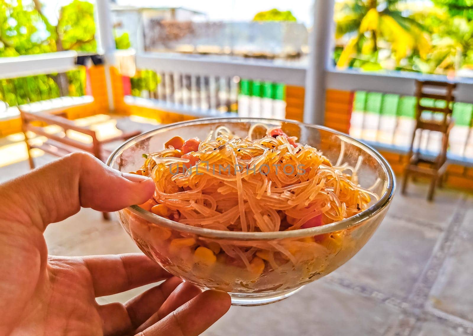 Dish of glass noodles with corn onions and tomatoes in Zicatela Puerto Escondido Oaxaca Mexico.