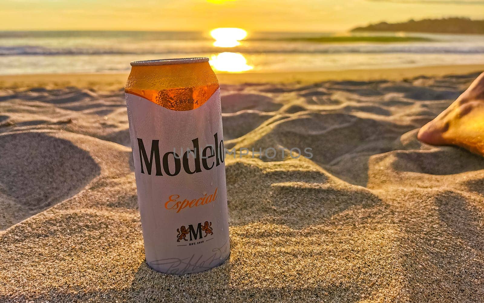 Modelo beer can on the beach at sunset in Zicatela Puerto Escondido Oaxaca Mexico.