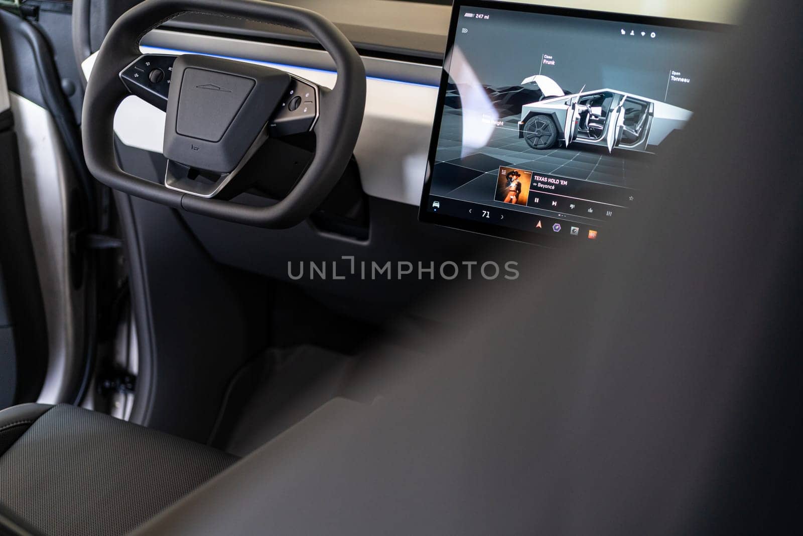 Denver, Colorado, USA-May 5, 2024-The interior of a Tesla Cybertruck showcasing its advanced touchscreen display, which is centrally located between the driver and passenger seats. This image highlights the modern design and technological features of the electric vehicle.