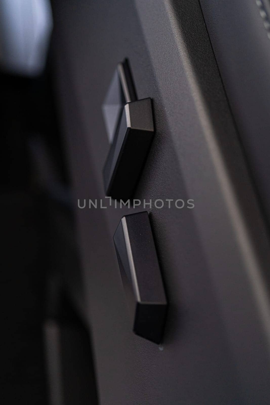 Denver, Colorado, USA-May 5, 2024-This image captures a close-up view of the seat adjustment buttons located in the Tesla Cybertruck, emphasizing the minimalist and sleek design of the vehicle interior controls.