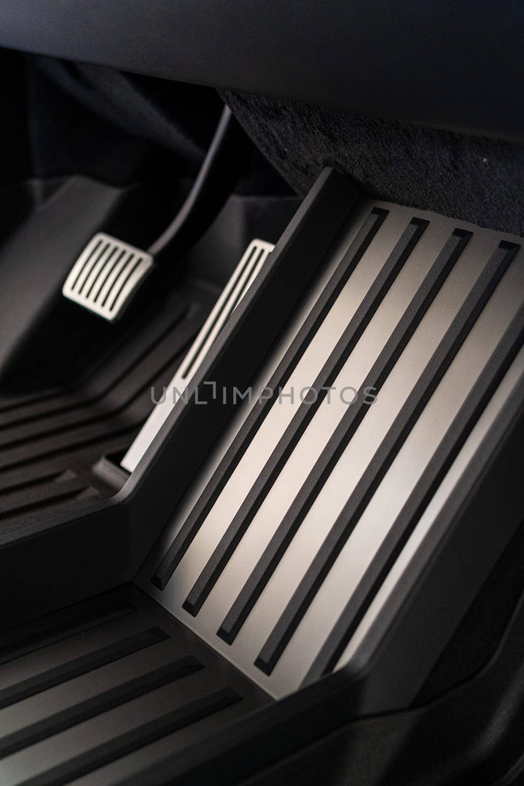 Denver, Colorado, USA-May 5, 2024-his image features a close-up view of the aluminum accelerator and brake pedals alongside the metal floor mat in a Tesla Cybertruck, highlighting the vehicle sleek and modern interior design.