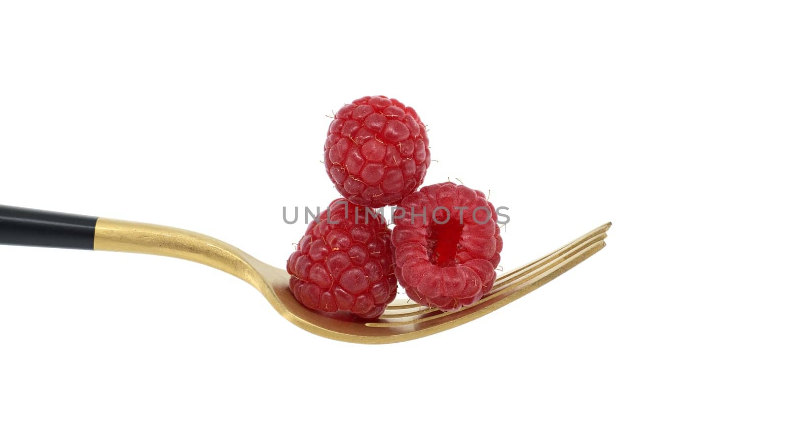 Ripe raspberries on a golden fork isolated on white background by NetPix