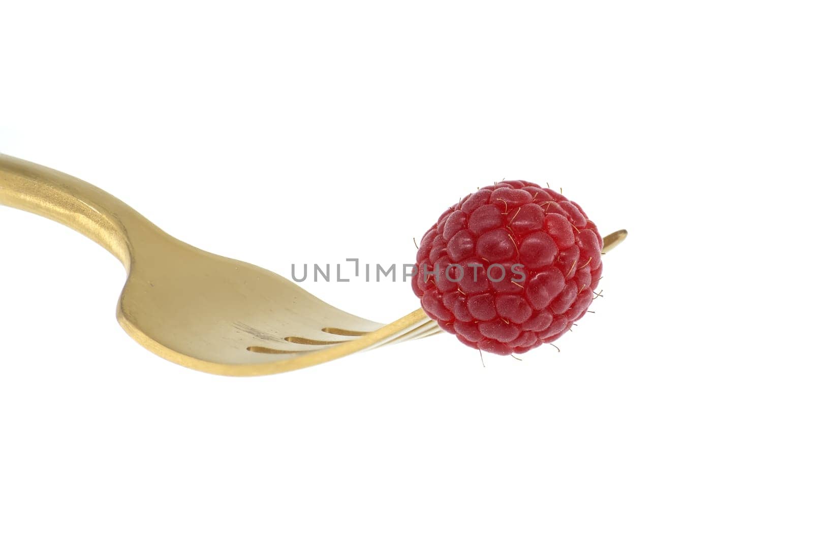 Fresh raspberry on gold fork isolated on white background by NetPix