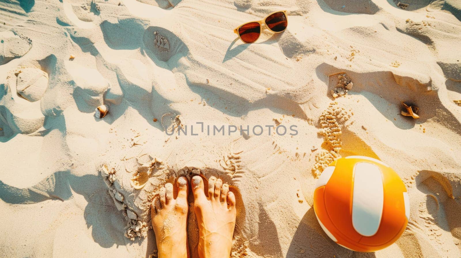 A beach ball and sunglasses are lying on the sandy shore, creating a colorful contrast against the landscape. Its a pictureperfect scene for leisure and recreation AIG50