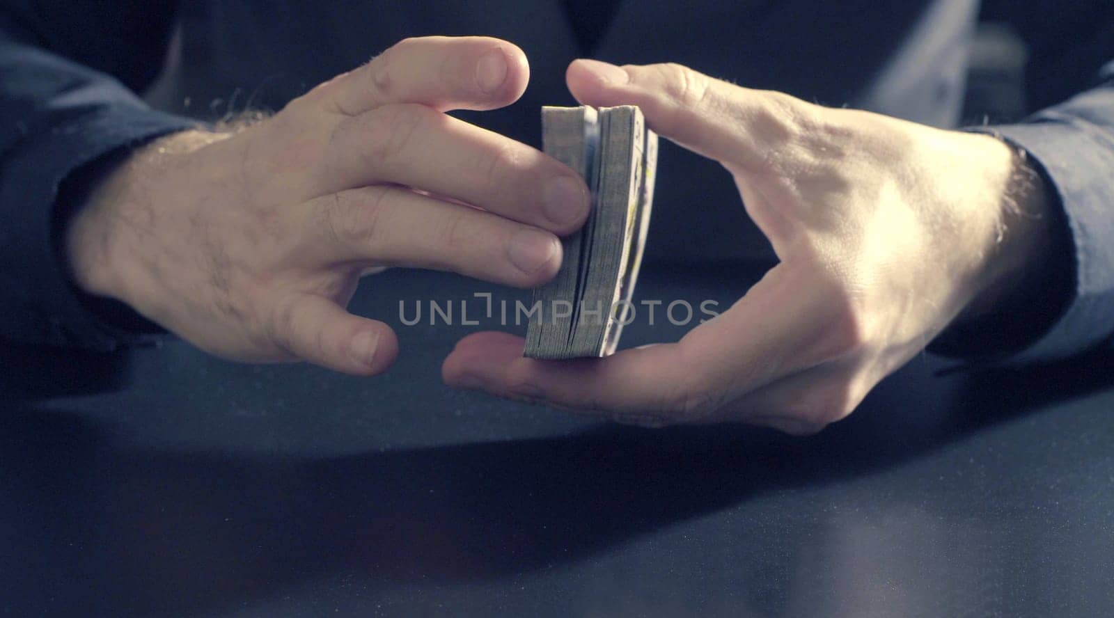 Man's hands shuffing cards by Chudakov