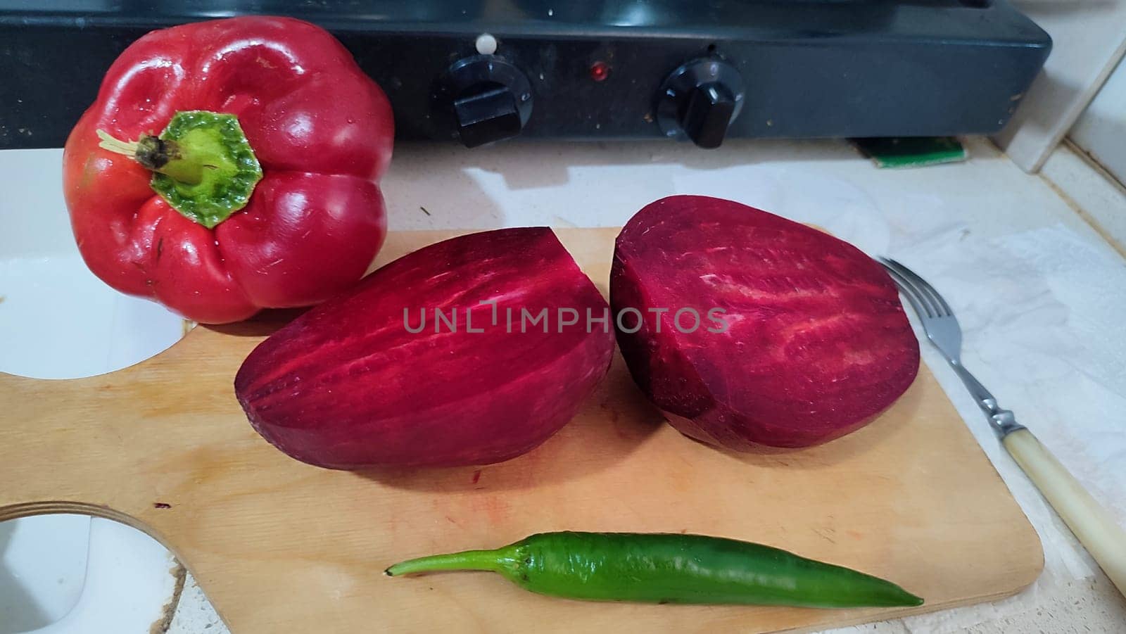 sweet red pepper, beets, garlic, green hot pepper, vegetables food in the kitchen, stove by Ply