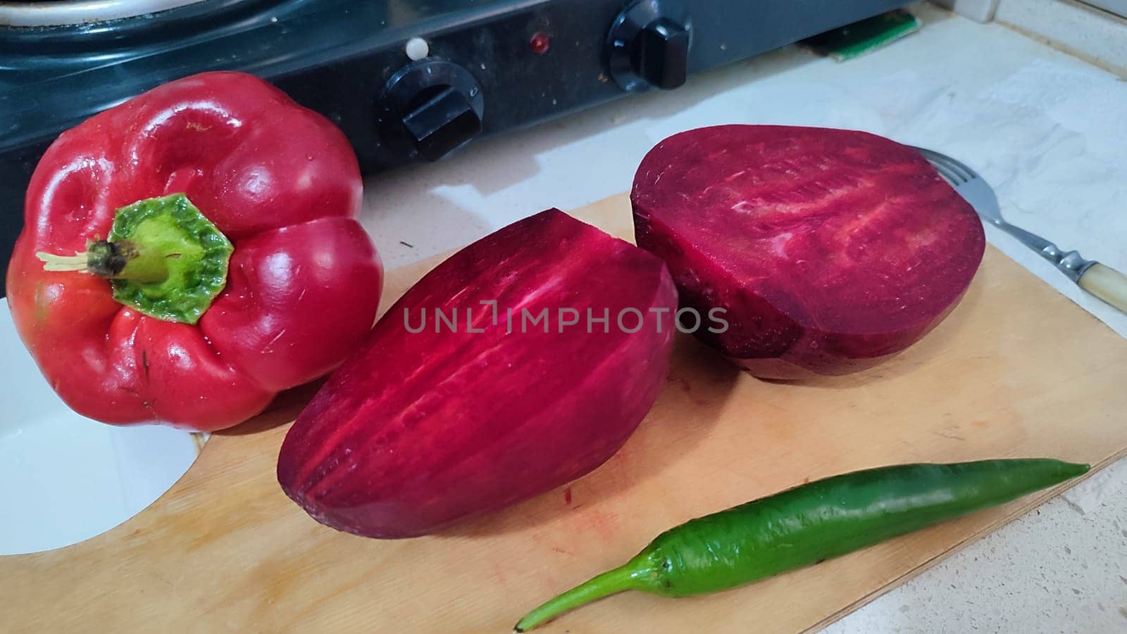 sweet red pepper, beets, garlic, green hot pepper, vegetables food in the kitchen, stove. High quality photo