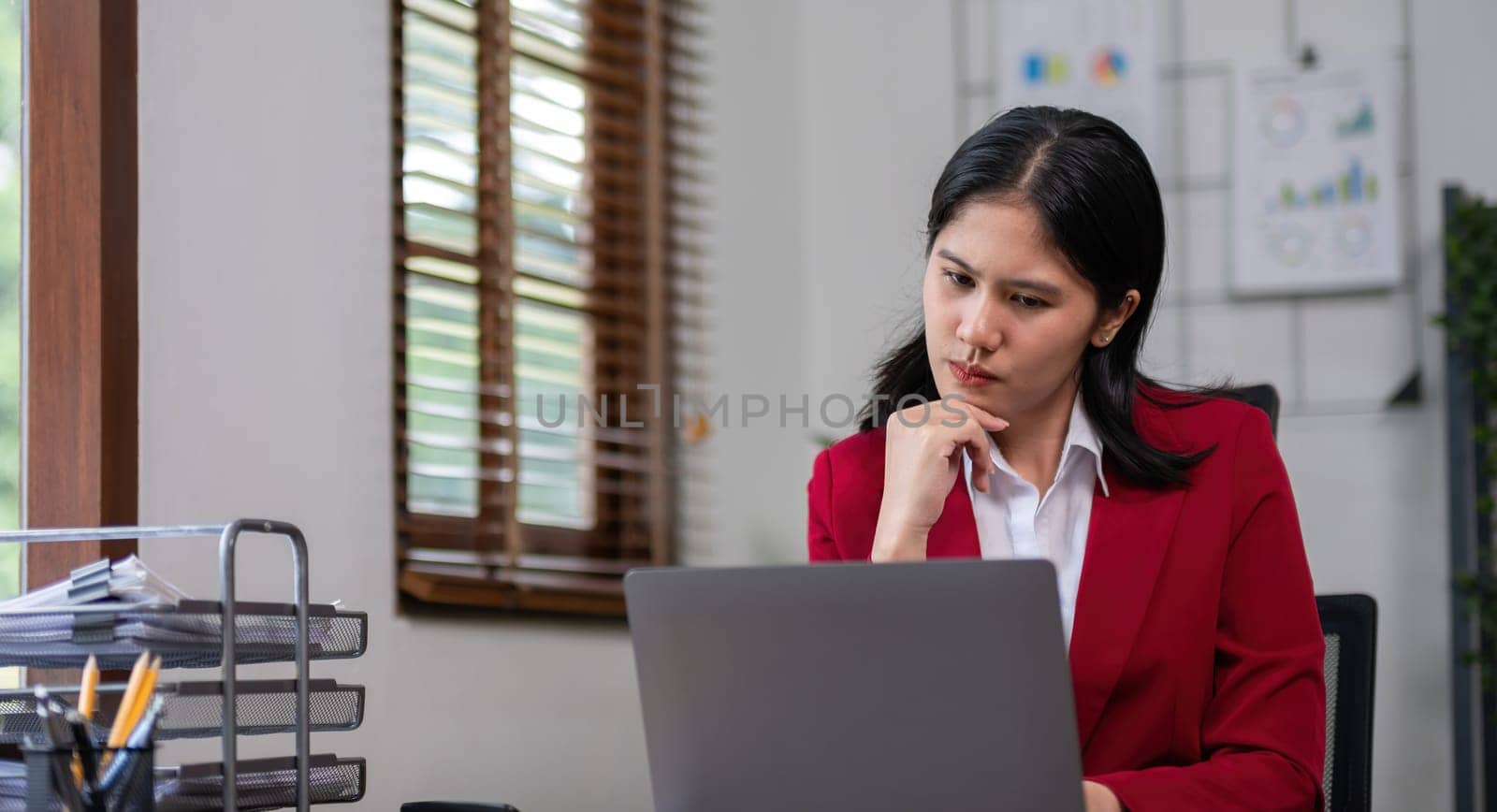 Young businesswoman has problems with her work in the office Feeling stressed and unhappy, showing a serious expression by wichayada