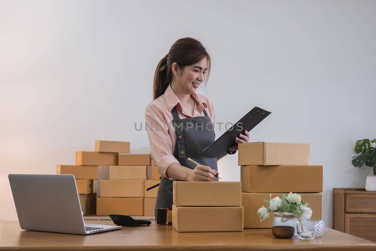 Startup small business entrepreneur SME, asian woman receive order on phone. Success young Asian small business owner home office, online sell marketing delivery.