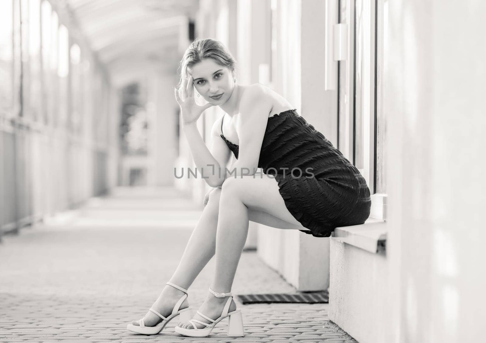 Young Girl Poses In Fashion Style On Street In Dress In Black And White Photo