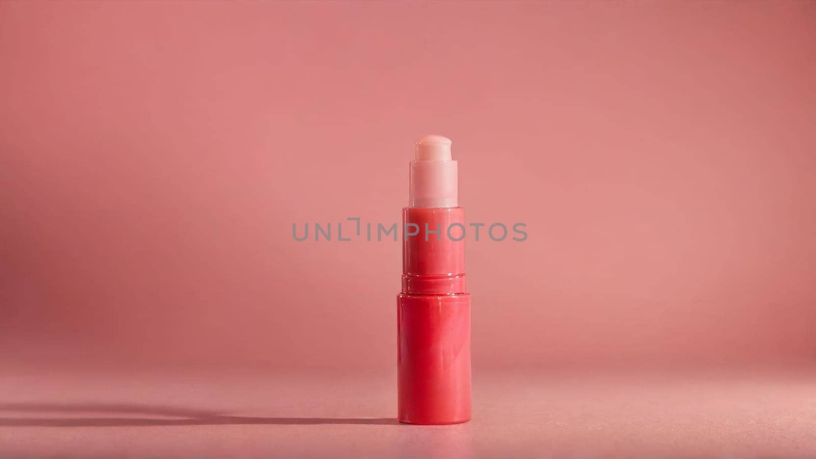 Hydrating lip balm with nourishing oils juicy shine conditioning swirls soft coral backdrop mockup by panophotograph