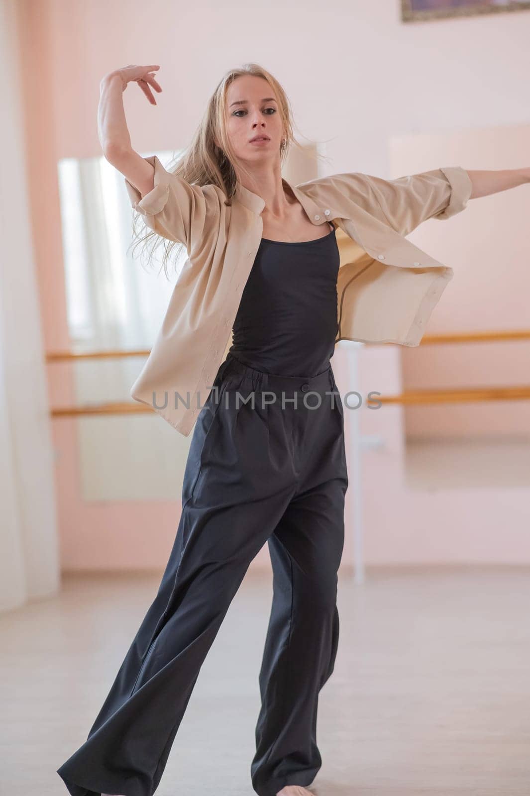 Caucasian woman dancing contemporary in ballet class. Rehearsal. Vertical photo