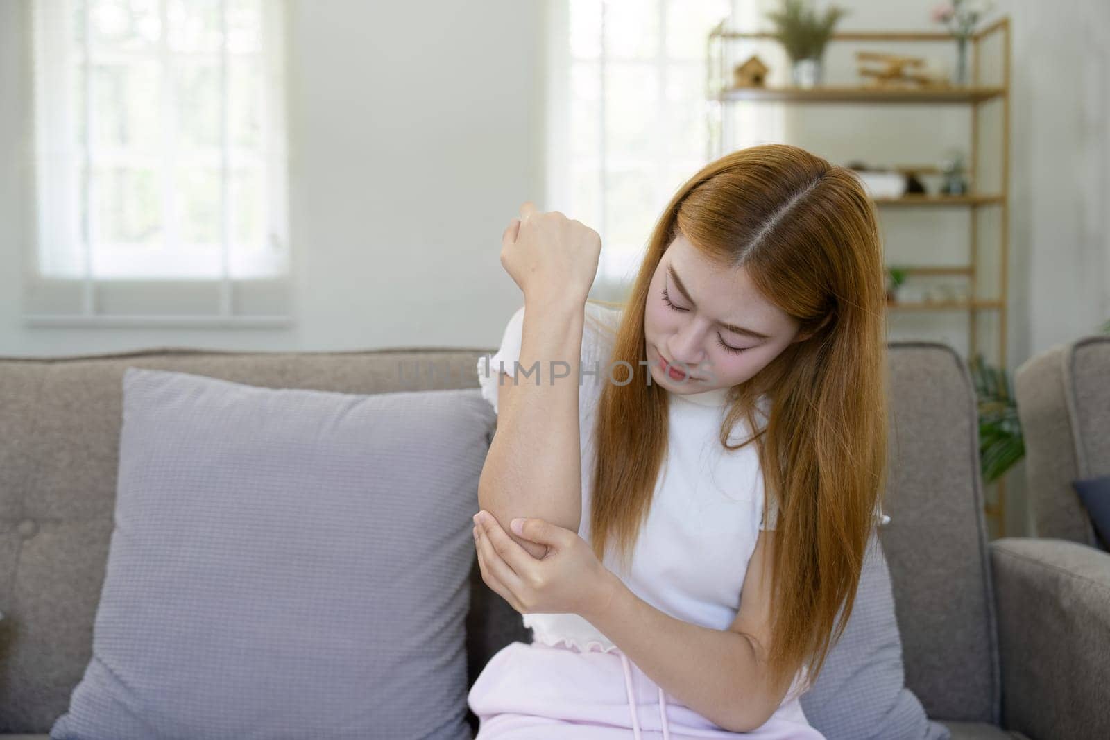 Arms Pain. Asian woman Suffering From Painful Feeling In Arm Muscles. health concept.