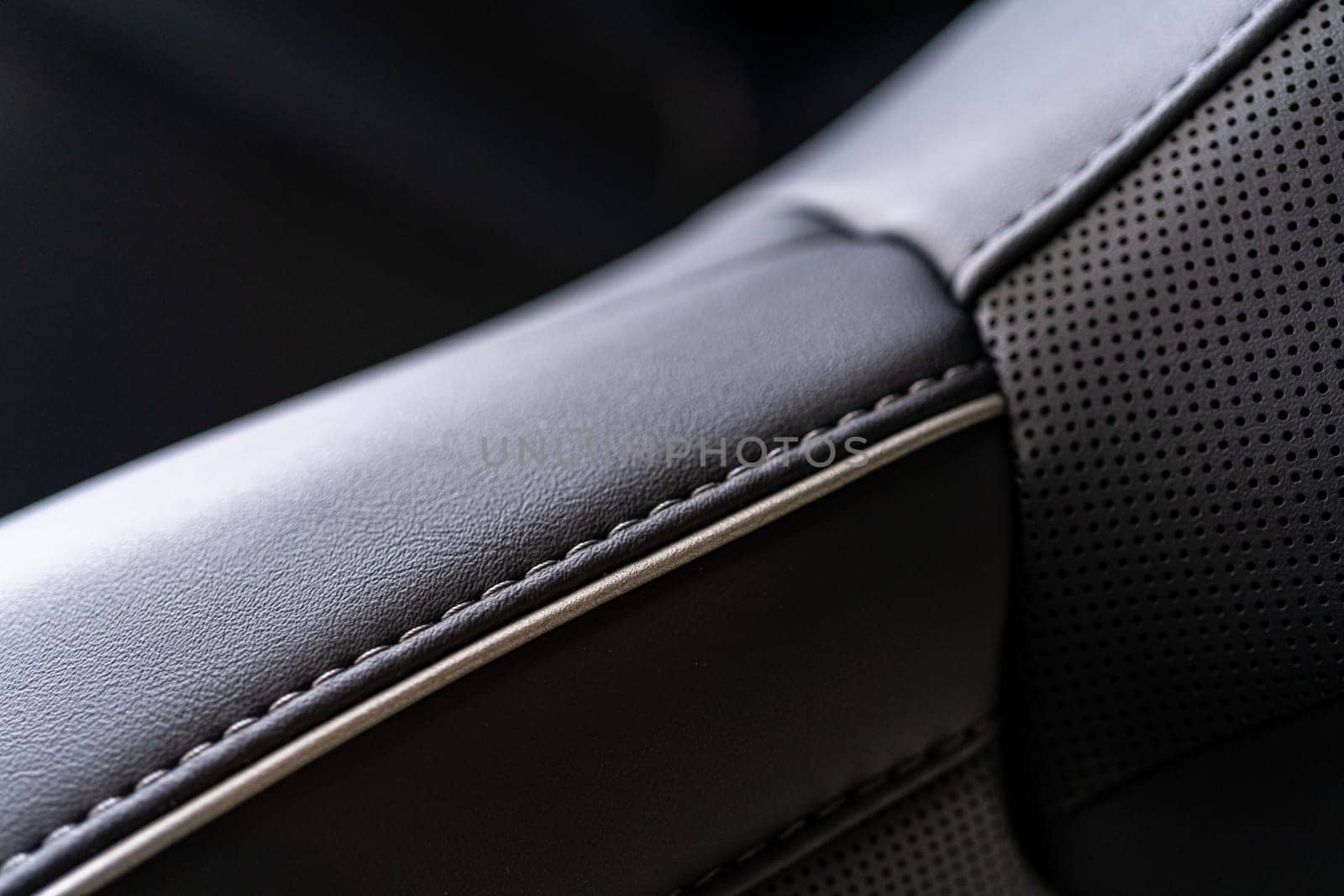 Denver, Colorado, USA-May 5, 2024-This image captures a detailed close-up view of the intricate stitching on a leather seat inside a Tesla Cybertruck, showcasing the high-quality materials and craftsmanship.