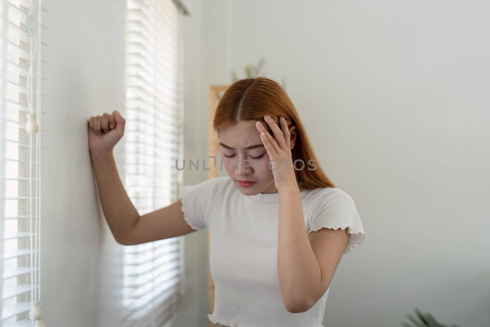 Woman asian people and health problem concept sick asian woman having headache at home.
