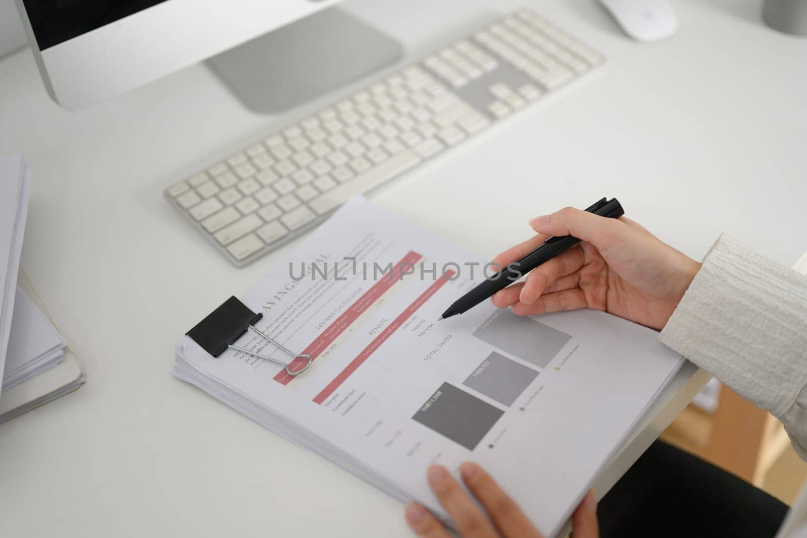 Closeup professional businesswoman writing strategy ideas on paper at office desk by prathanchorruangsak