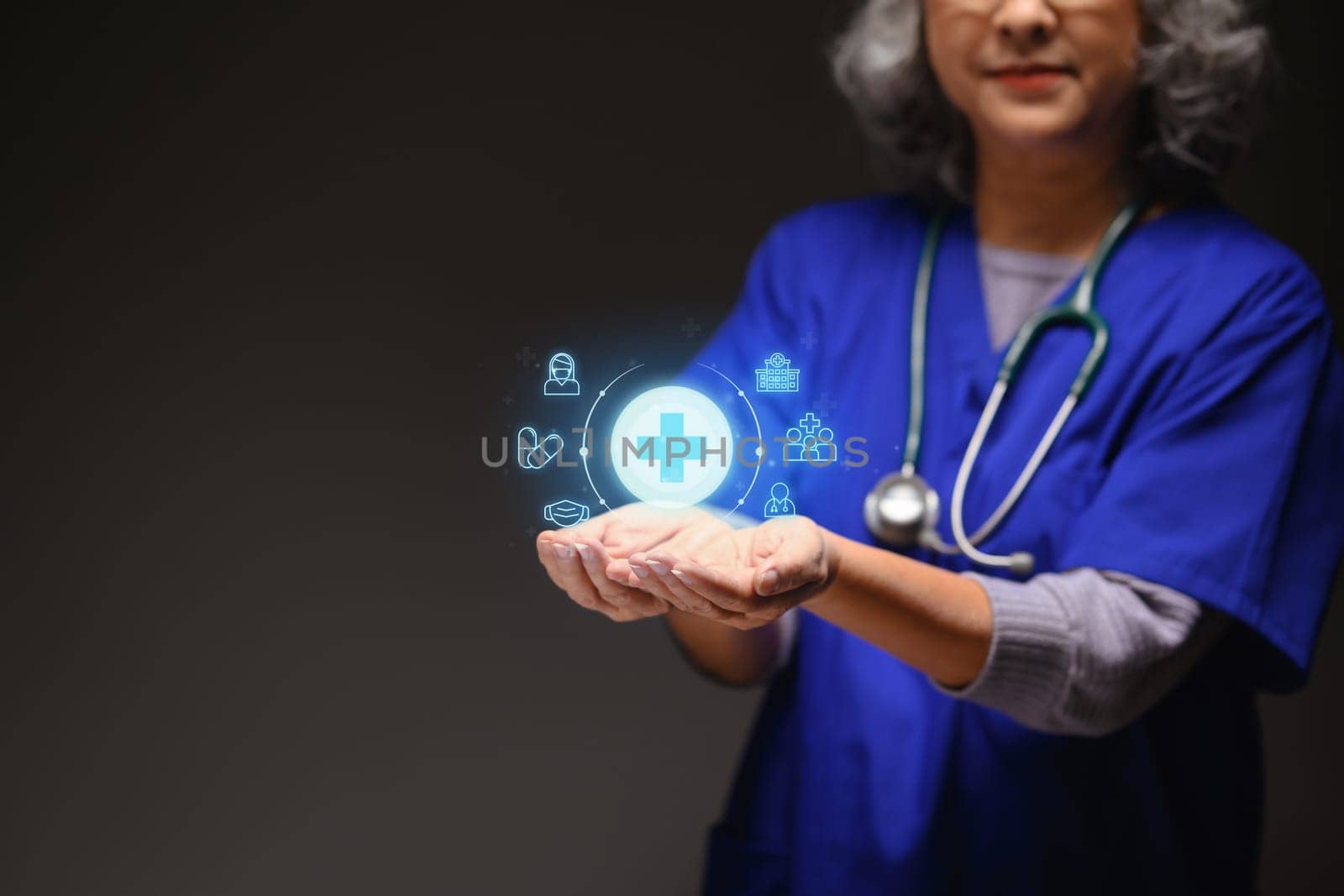 Senior doctor holding blue virtual plus sign. Health insurance and medical check up concept by prathanchorruangsak