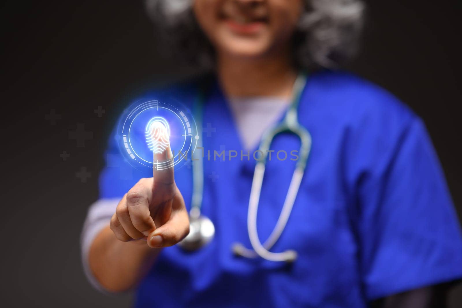 Senior doctor using fingerprint to access medical database. Medical technology and futuristic concept.