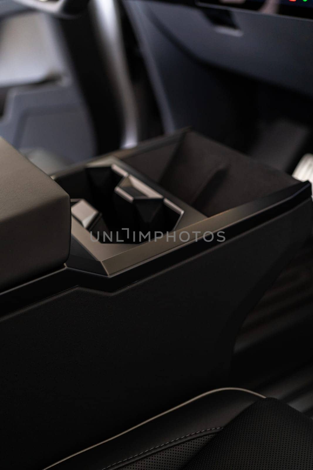Denver, Colorado, USA-May 5, 2024-This image offers an interior view of the Tesla Cybertruck, highlighting the central console with its geometric cup holders and the prominent touch screen display that controls various vehicle functions, embodying Tesla modern design ethos.