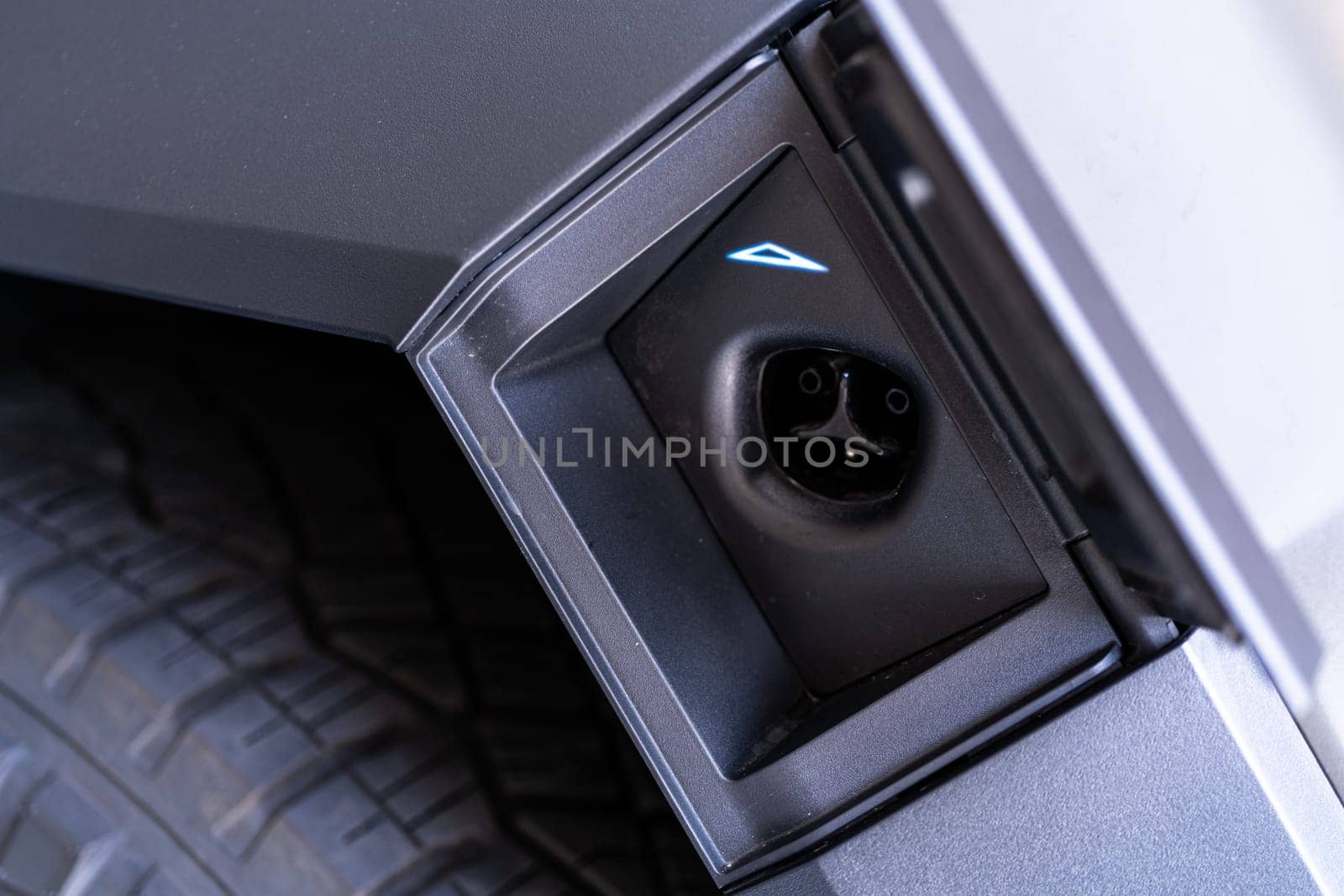 Denver, Colorado, USA-May 5, 2024-This image captures the charging port of the Tesla Cybertruck, showcasing the sleek and functional design that facilitates easy access for electric charging, emphasizing Tesla commitment to sustainable and innovative automotive solutions.