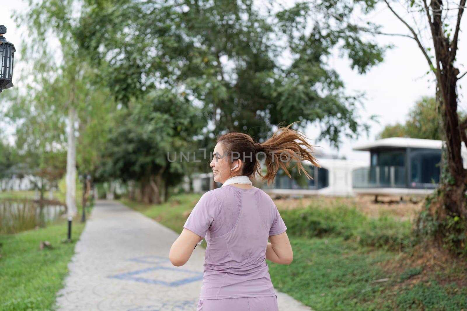 Running woman. Female Runner Jogging during Outdoor Workout in a Park. Healthy lifestyle. Morning by itchaznong