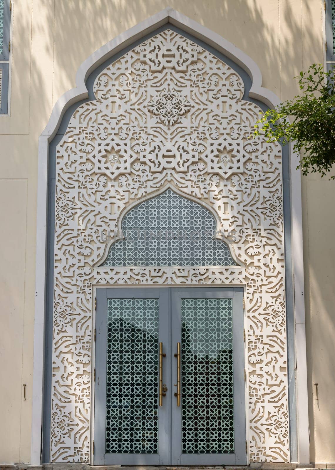 Bangkok, Thailand - Apr 15, 2024 - Entrance door and Decorated arch wall of Bang O Mosque. An Islamic architecture design, Copy space, Selective focus.
