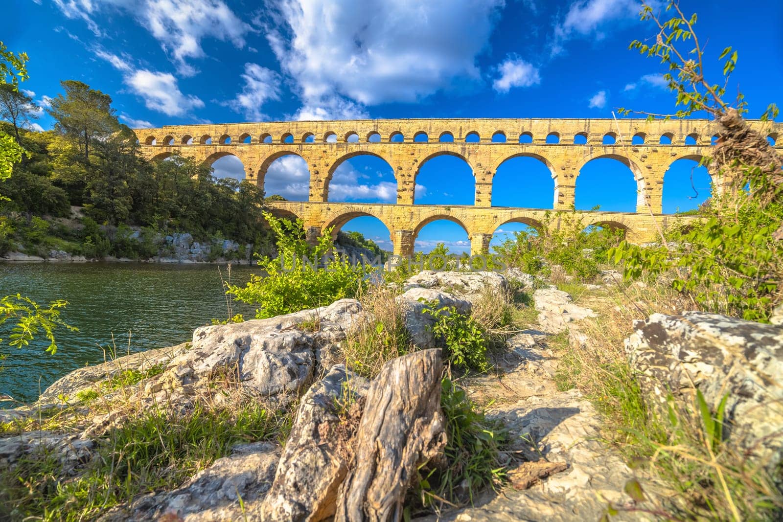 The Pont du Gard ancient Roman aqueduct bridge built in the first century AD to carry water to Nîmes. It crosses the river Gardon near the town of Vers-Pont-du-Gard in southern France.