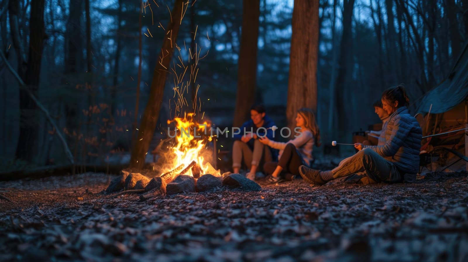 A fun camping event with a group of people sitting around a tent, enjoying the warmth of a fire, amidst the beautiful forest landscape. AIG41