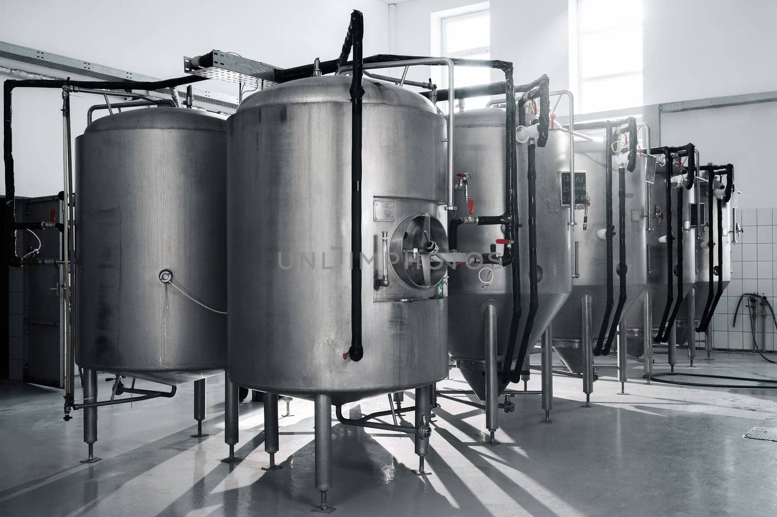 interior of a modern factory brewery with tanks inside