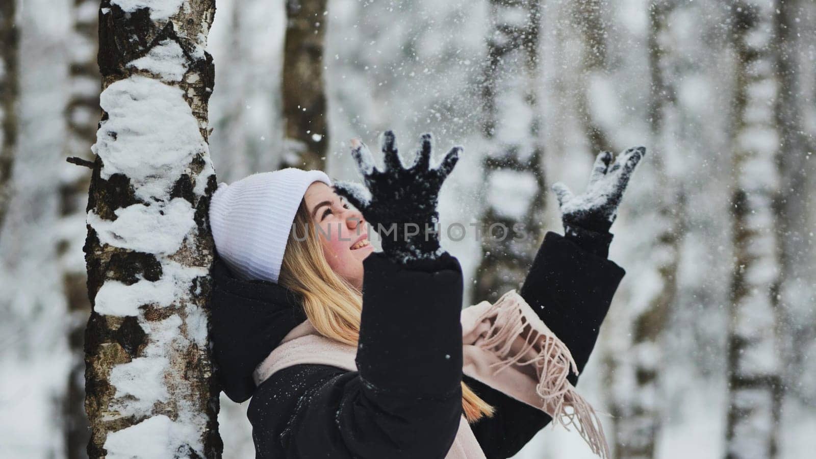 Teenage girl playing with snow