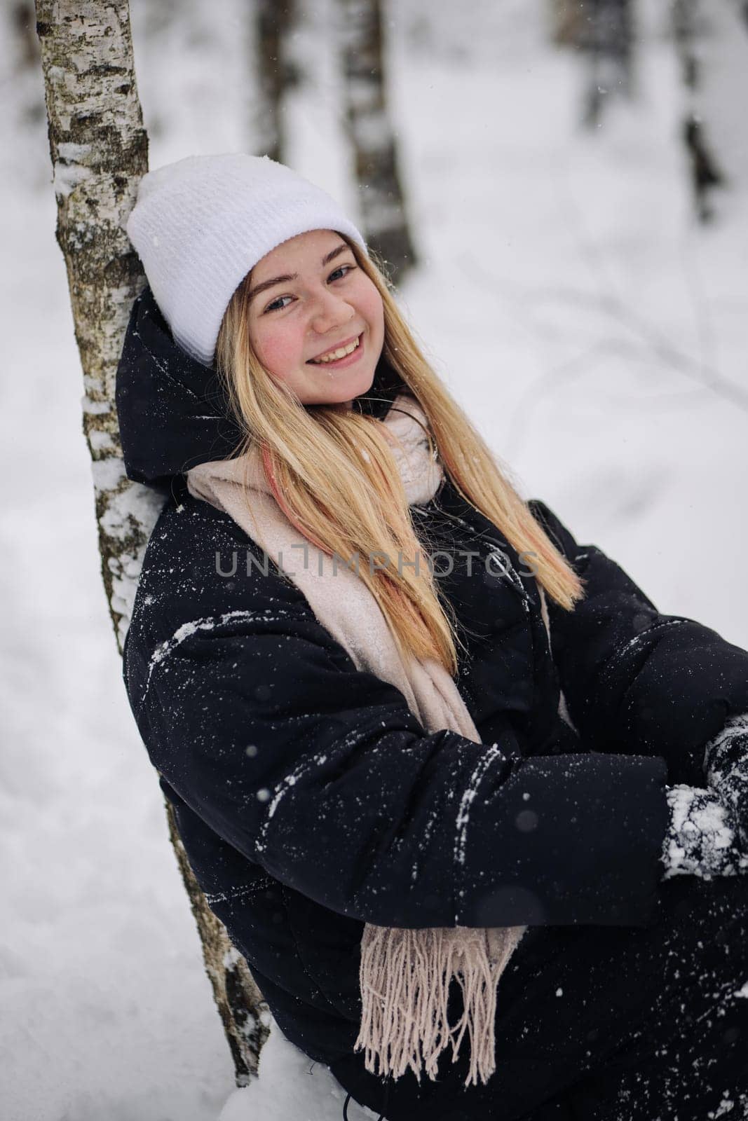 Portrait of a teenage girl in winter in the woods