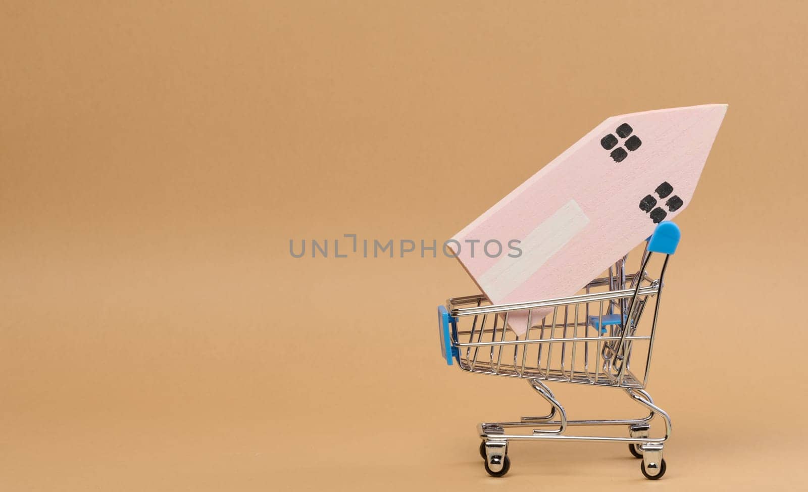 Wooden house and miniature shopping cart, representing the concept of real estate purchase, rental growth by ndanko
