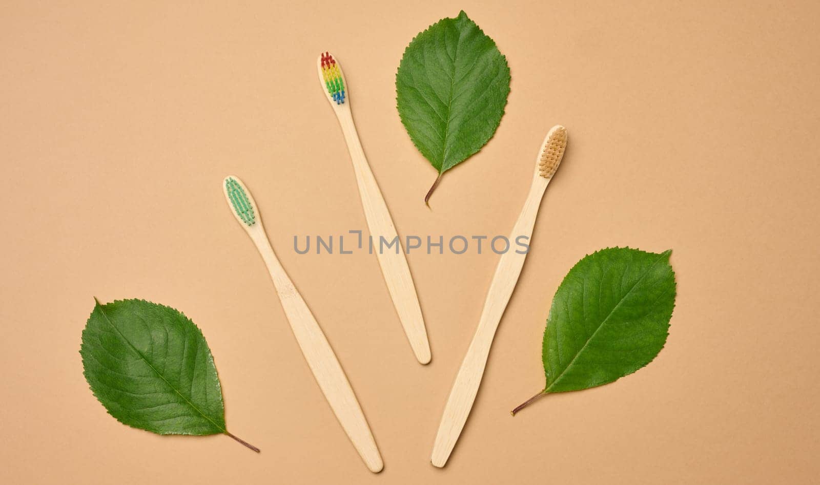 Wooden toothbrush on a brown background, plastic rejection concept, zero waste, flat lay 