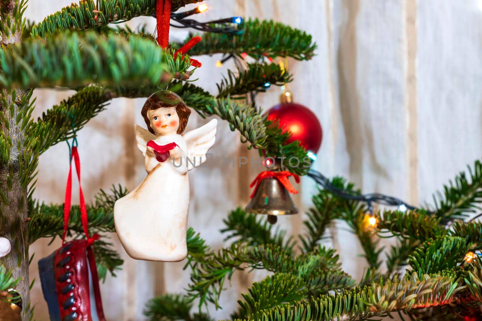 Beautiful little angel and balls on the Christmas tree. Festive decoration  by EdVal