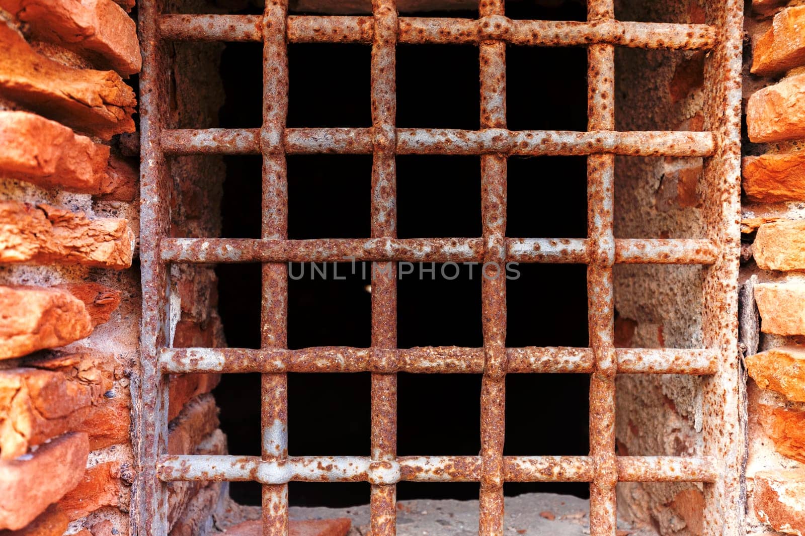 Old rust metal lattice on the prison window 